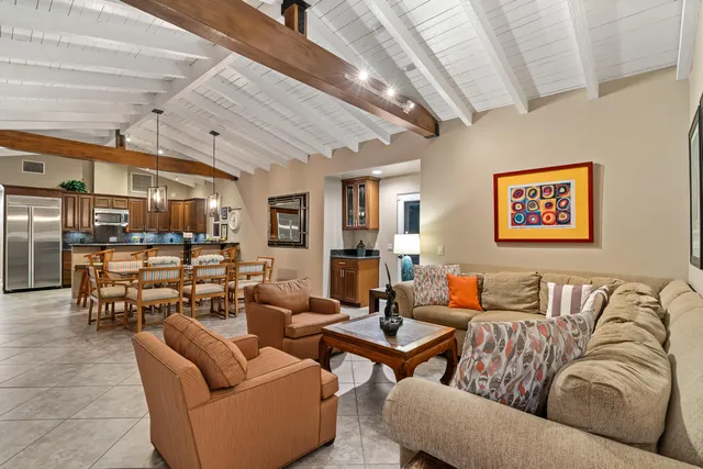 a living room with furniture a ceiling fan and a rug