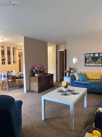 a living room with furniture and flowers