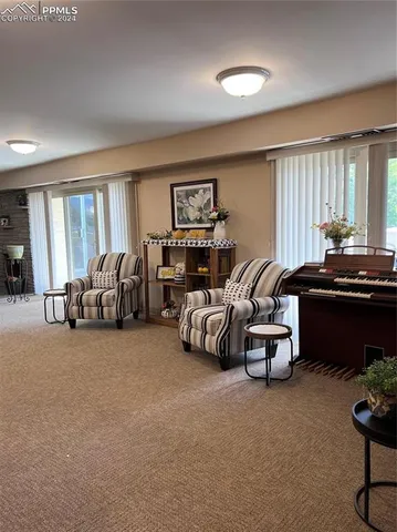 a living room with furniture flowerpot and window