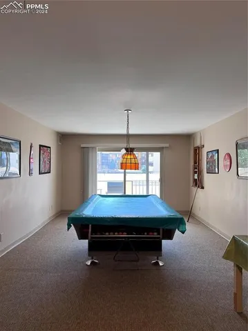 a room with pool table and window