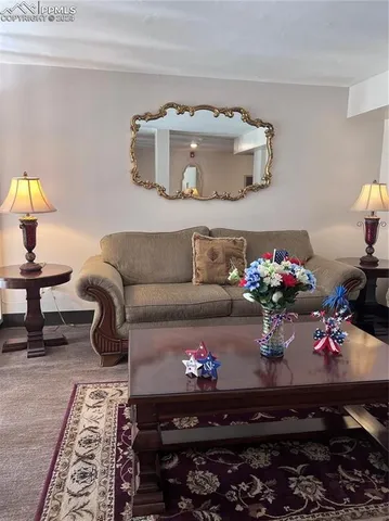 a living room with furniture and flowers