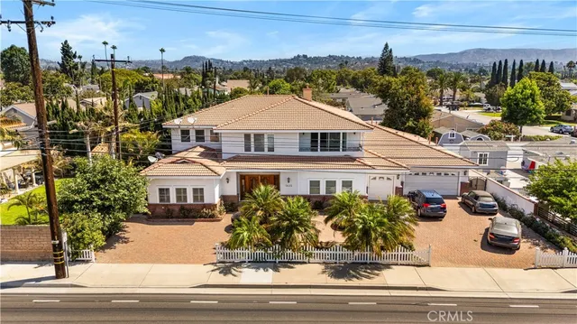 a view of a white house with a yard