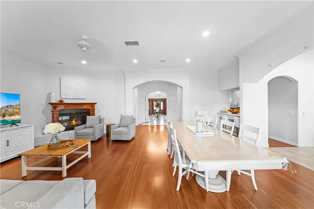 a living room with furniture fireplace and wooden floor