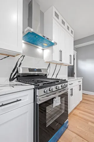a kitchen with a refrigerator and a stove