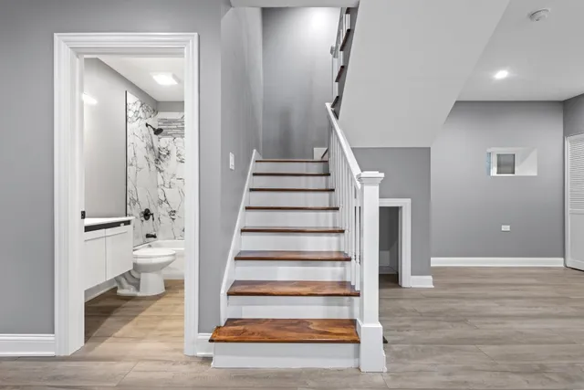 a view of room with stairs and wooden floor