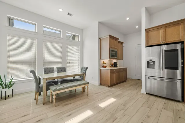a kitchen with granite countertop a refrigerator and wooden floor