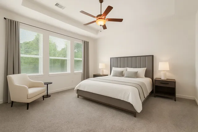 a spacious bedroom with a bed and a couch