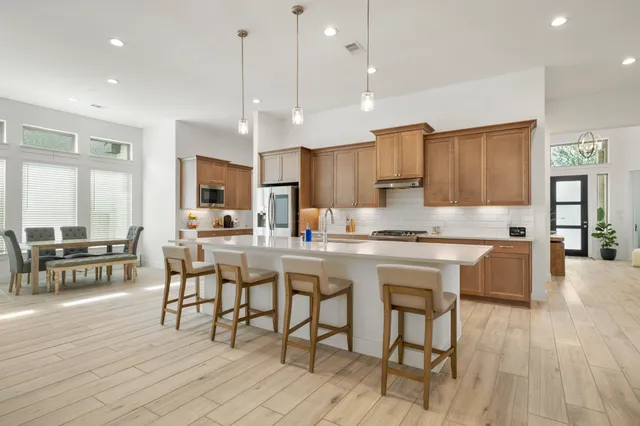 a kitchen with counter space dining table and chairs