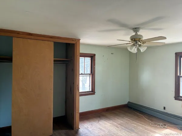 a view of a room with a fan and a window