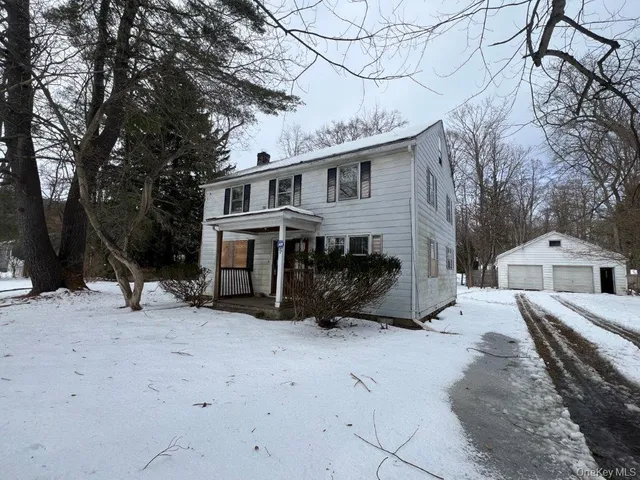 a view of a house with a yard covered in snow