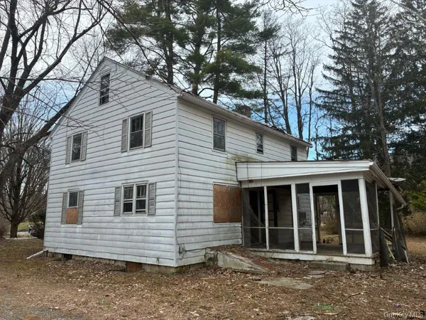 a view of a white house with a large window