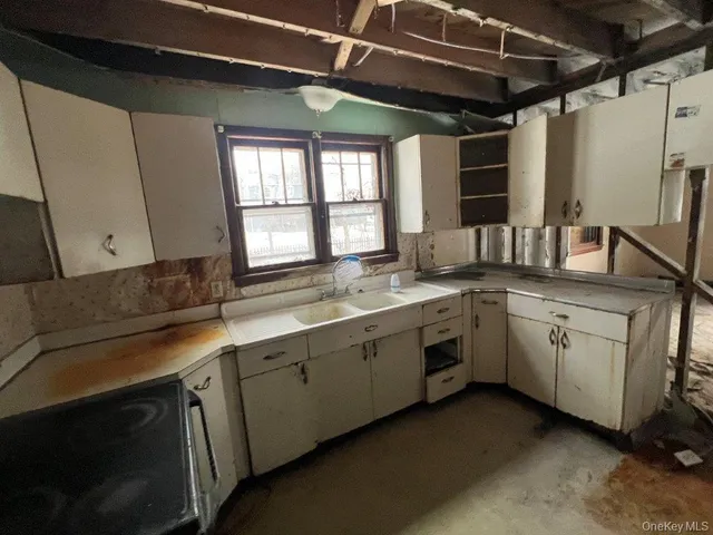 a kitchen with sink and window