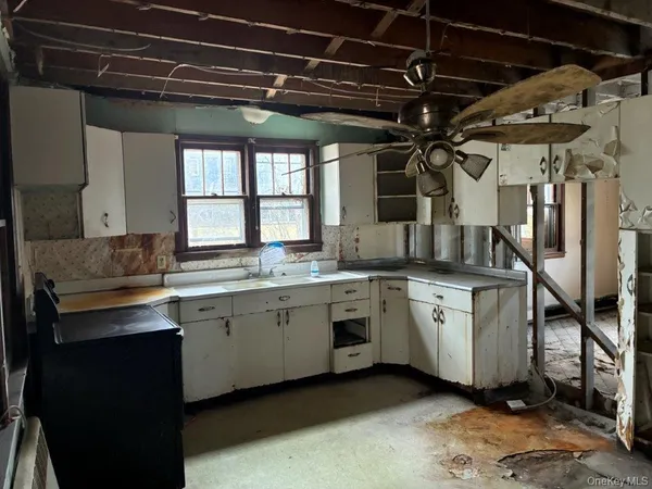 a kitchen with sink and cabinets