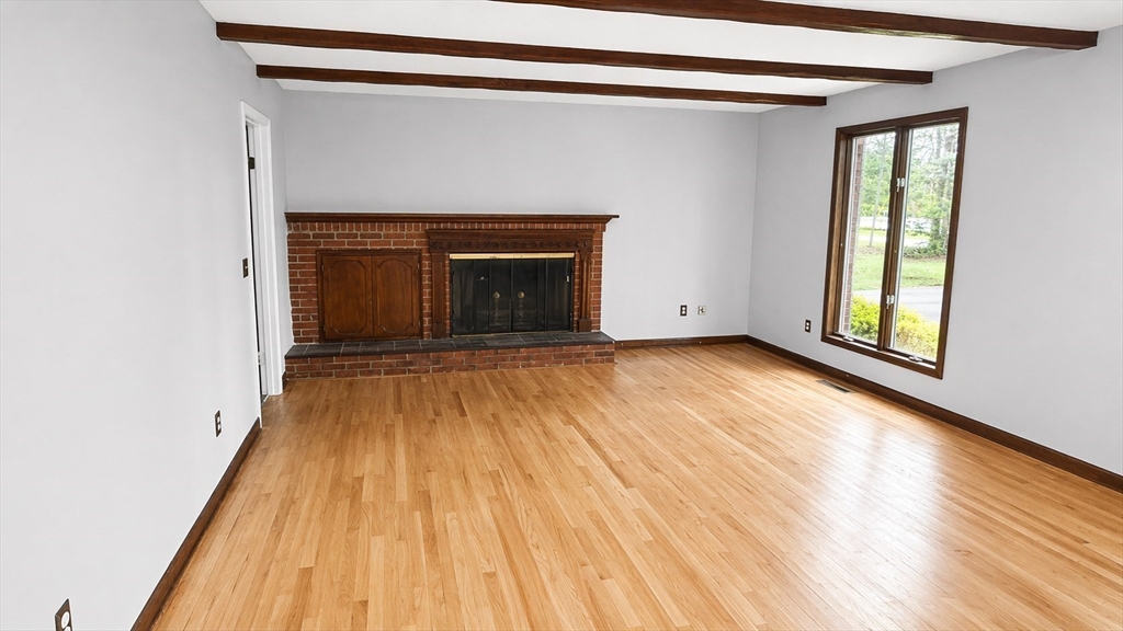 12 Woodland Road Westfield, MA 01085 - Photo 29 of 29 a view of empty room with wooden floor and fireplace