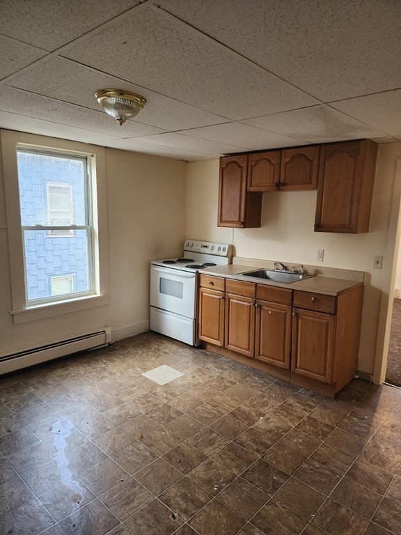 26 Hawley Street Worcester, MA 01609 - Photo 21 of 36 a kitchen with stainless steel appliances granite countertop a stove sink and cabinets