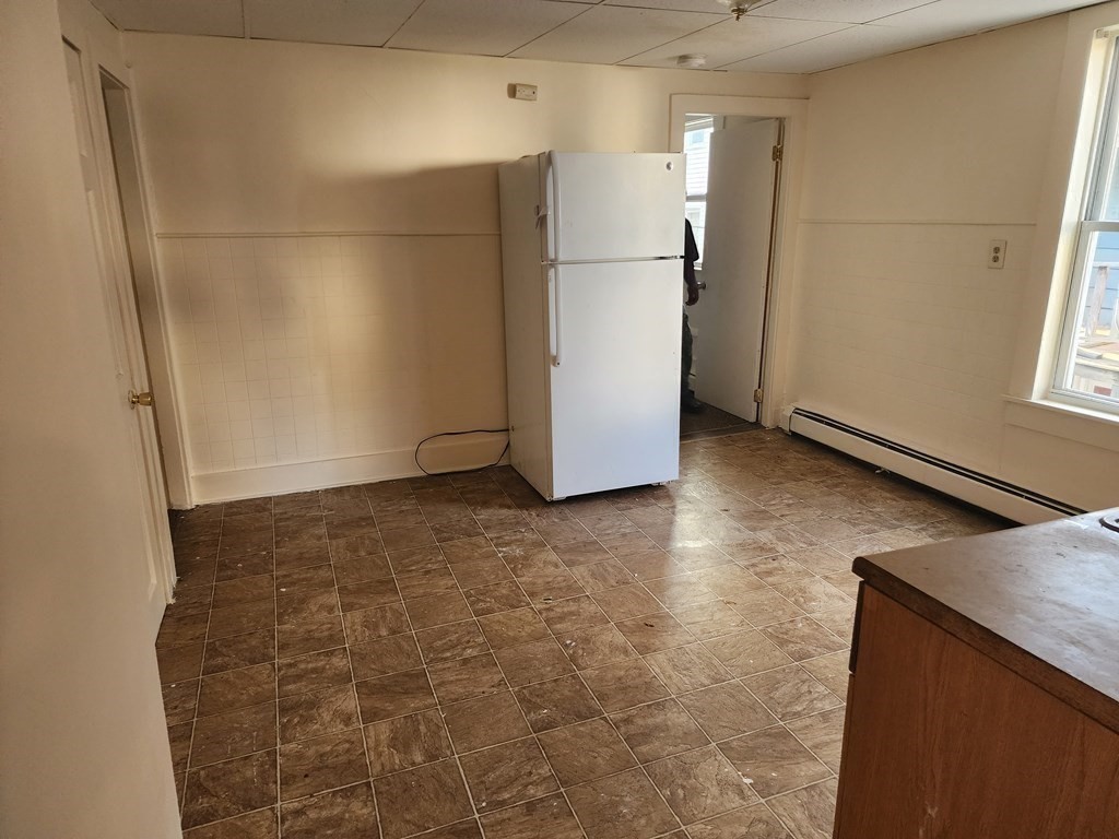 26 Hawley Street Worcester, MA 01609 - Photo 23 of 36 a view of a refrigerator in kitchen and an empty room