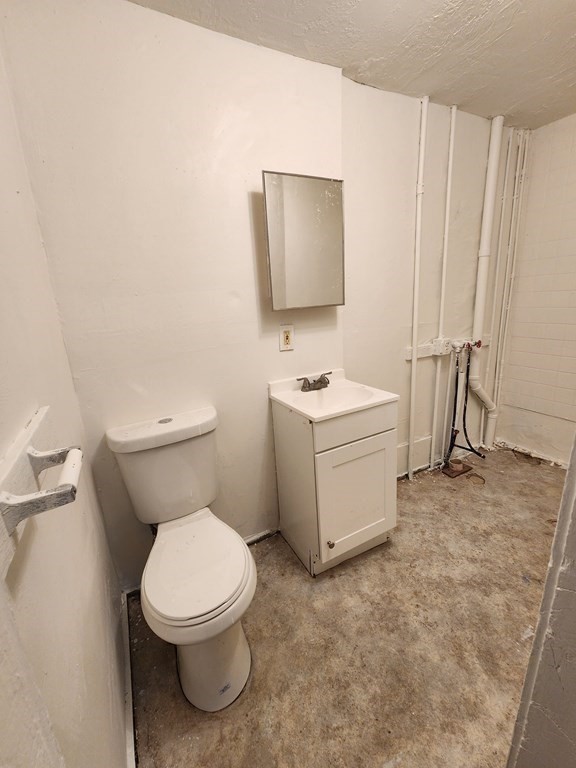 26 Hawley Street Worcester, MA 01609 - Photo 27 of 36 a white toilet sitting next to a bathroom sink