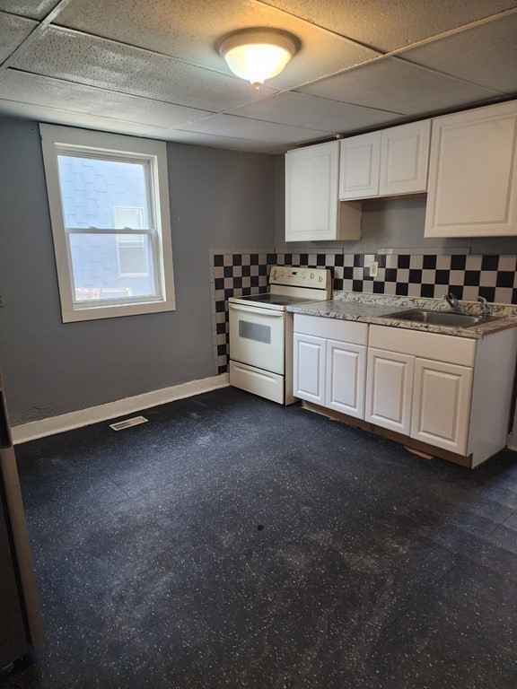 26 Hawley Street Worcester, MA 01609 - Photo 5 of 36 a kitchen with granite countertop white cabinets and appliances