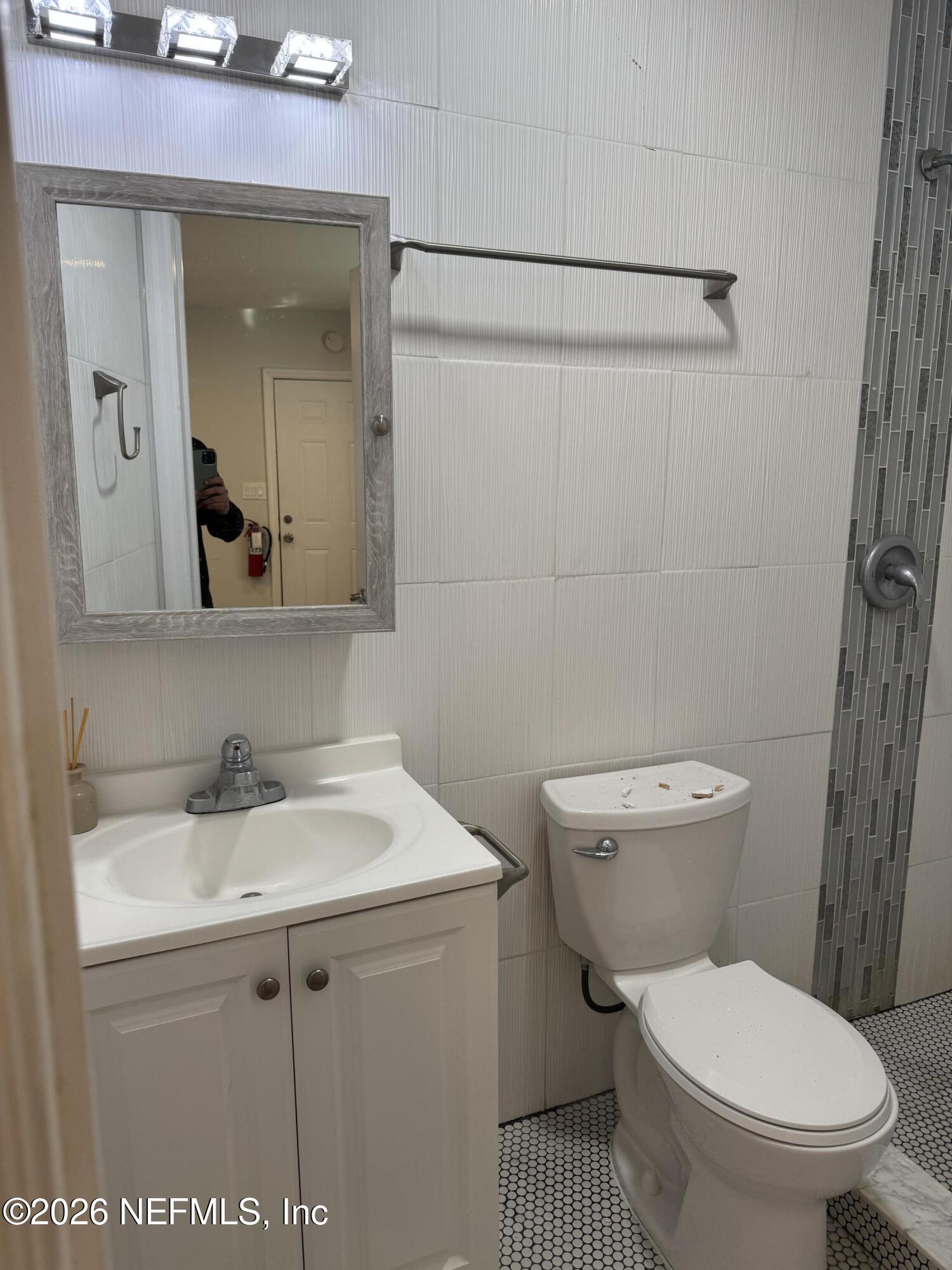 2357 College Street Jacksonville, FL 32204 - Photo 11 of 12 a bathroom with a sink toilet and mirror