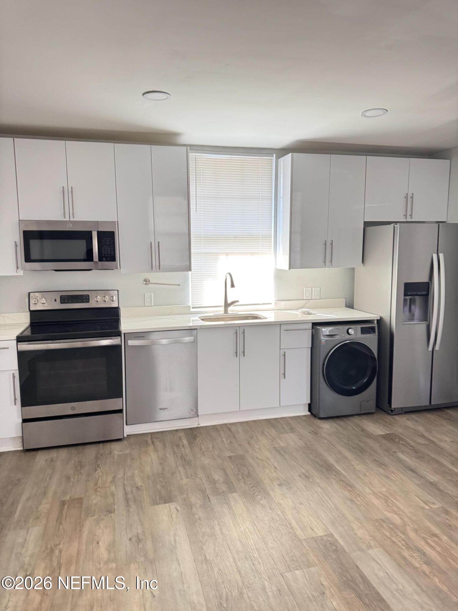 2357 College Street Jacksonville, FL 32204 - Photo 3 of 12 a kitchen with stainless steel appliances a refrigerator sink and cabinets