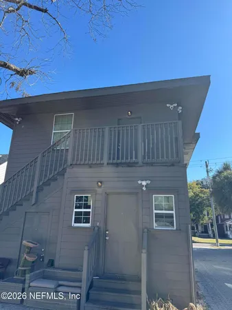 a view of a house with wooden deck
