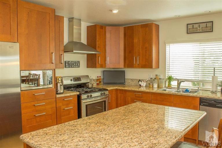 6360 Keystone Street Simi Valley, CA 93063 - Photo 1 of 17 a kitchen with stainless steel appliances granite countertop wooden cabinets a stove top oven a sink and dishwasher