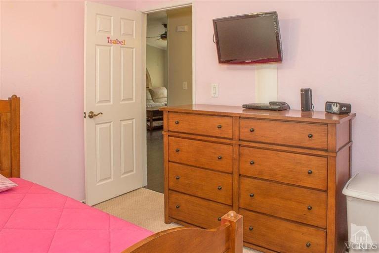 6360 Keystone Street Simi Valley, CA 93063 - Photo 11 of 17 a bedroom with a bed and a flat tv screen in it