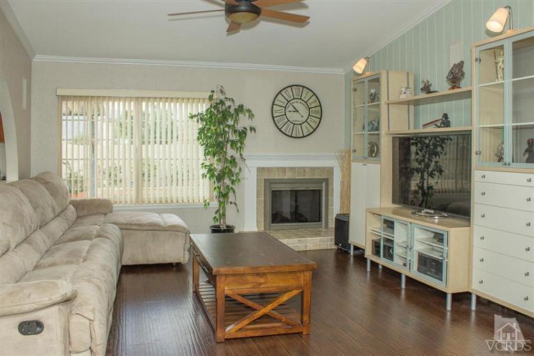 6360 Keystone Street Simi Valley, CA 93063 - Photo 5 of 17 a living room with furniture a fireplace and a window