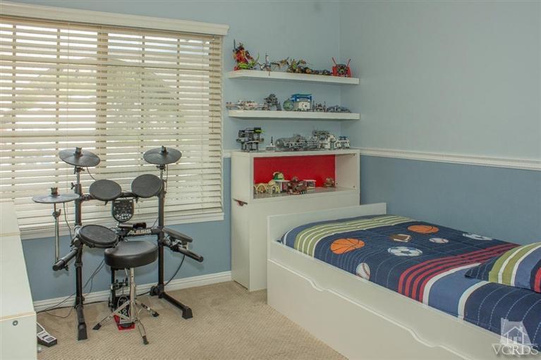 6360 Keystone Street Simi Valley, CA 93063 - Photo 8 of 17 a bedroom with a bed and a table in it