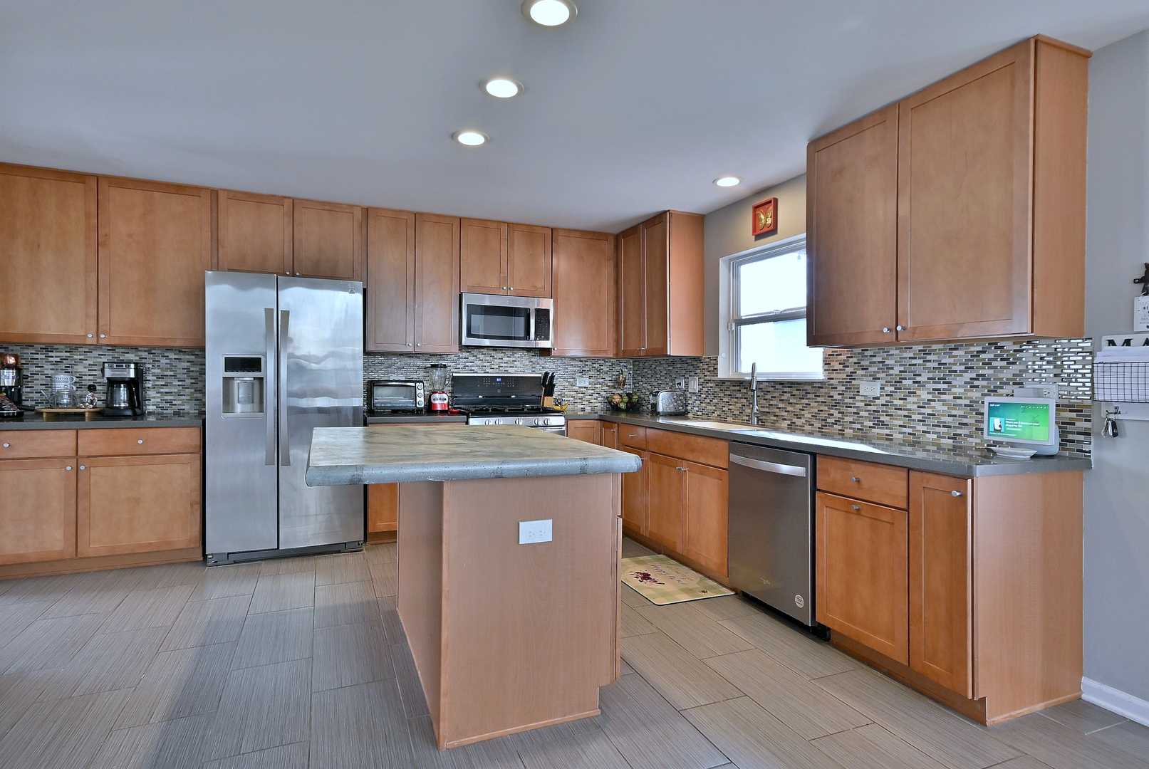 579 Homestead Court Aurora, IL 60506 - Photo 15 of 45 a kitchen with kitchen island wooden cabinets stainless steel appliances and a window