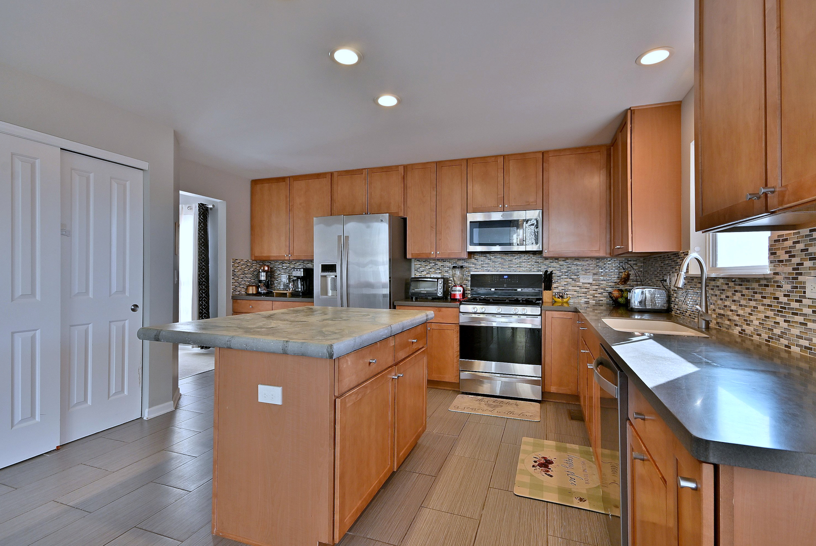 579 Homestead Court Aurora, IL 60506 - Photo 16 of 45 a kitchen with stainless steel appliances granite countertop a stove top oven a sink and dishwasher