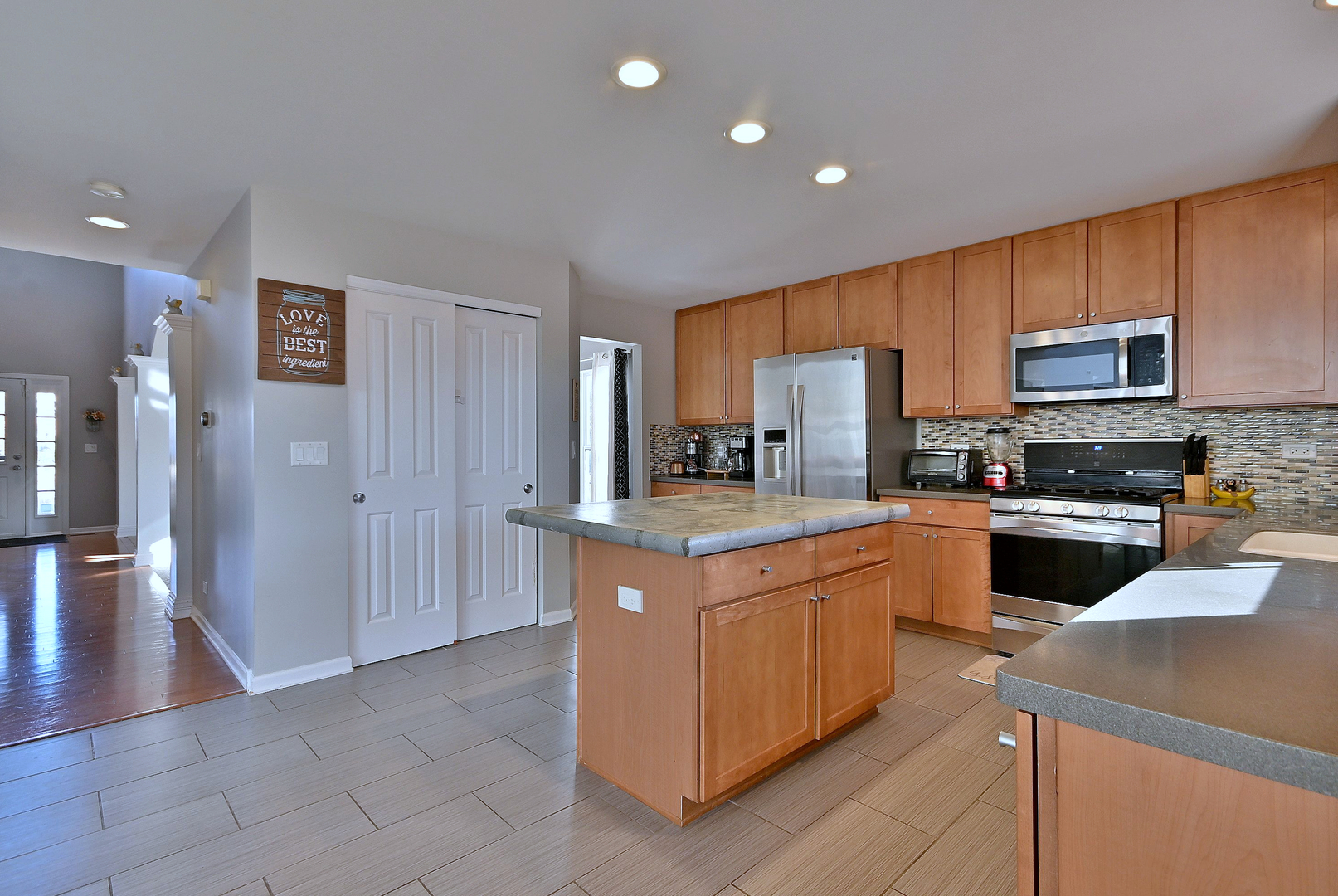 579 Homestead Court Aurora, IL 60506 - Photo 17 of 45 a kitchen with stainless steel appliances granite countertop a refrigerator stove and a sink