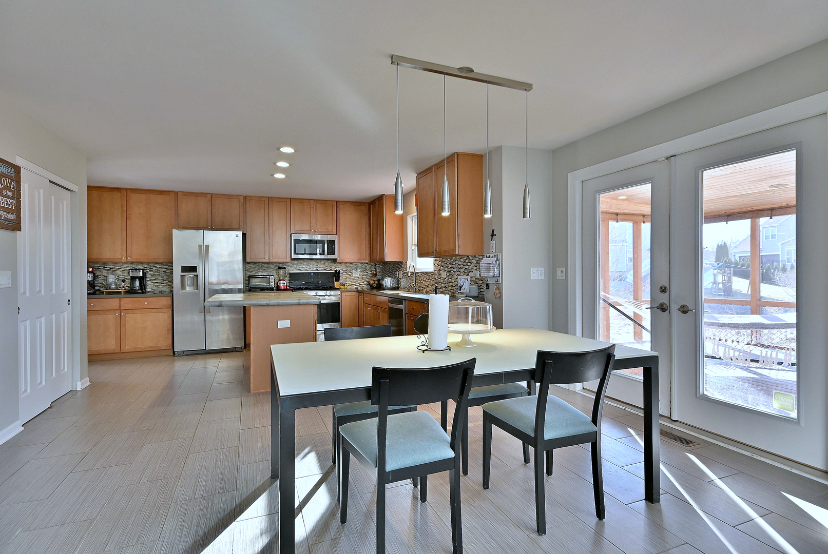 579 Homestead Court Aurora, IL 60506 - Photo 20 of 45 a kitchen with a dining table chairs and refrigerator