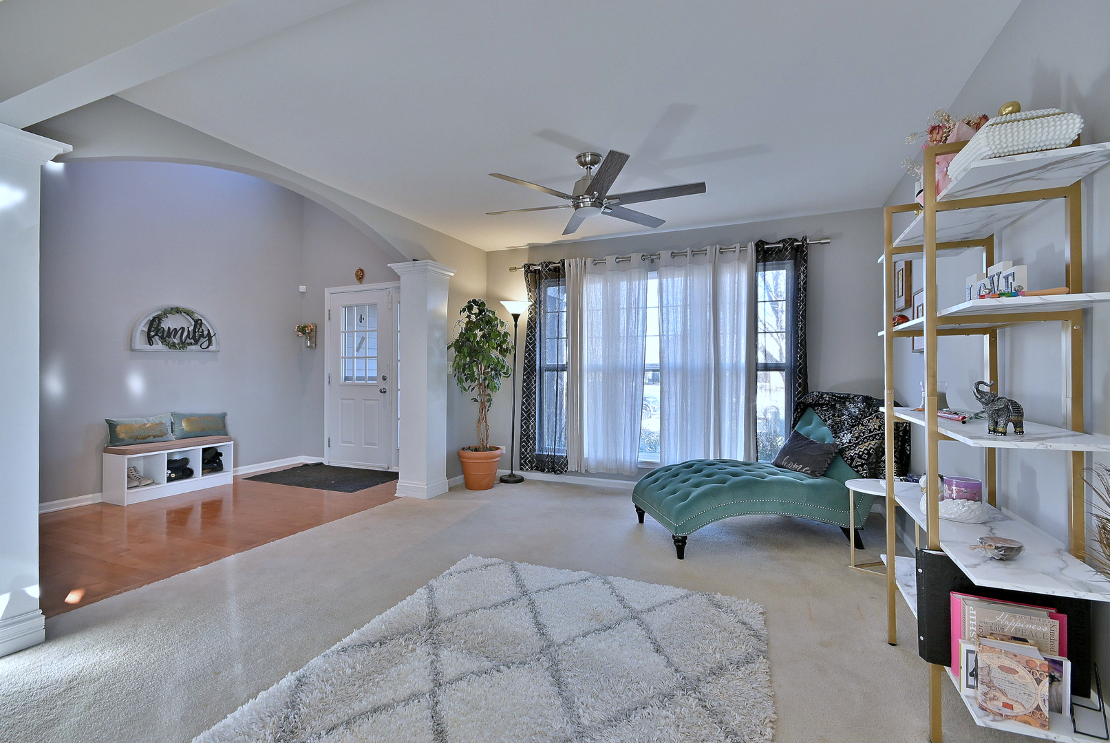 579 Homestead Court Aurora, IL 60506 - Photo 7 of 45 a living room with furniture a rug and a chandelier