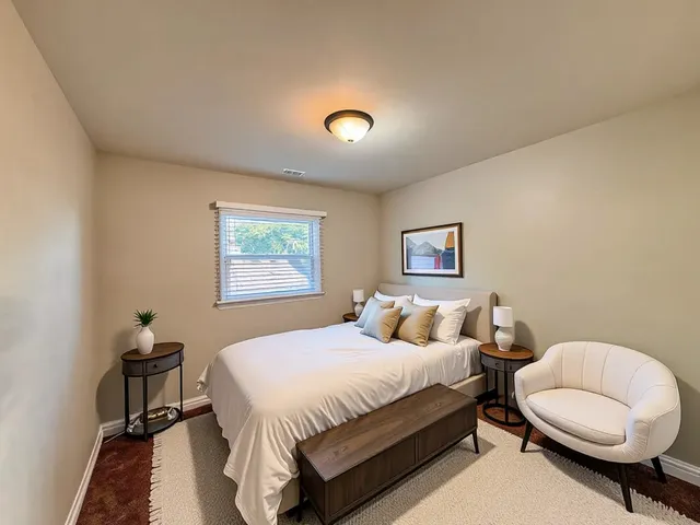 a bedroom with a bed and a lamp with wall painting