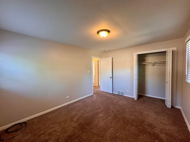an empty room with closet area