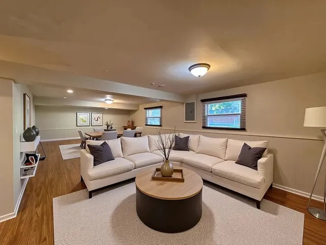 a living room with furniture and a wooden floor