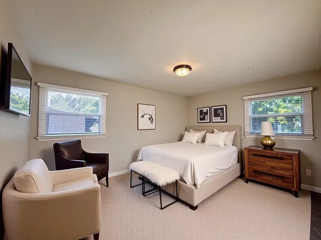 a spacious bedroom with a bed and a couch