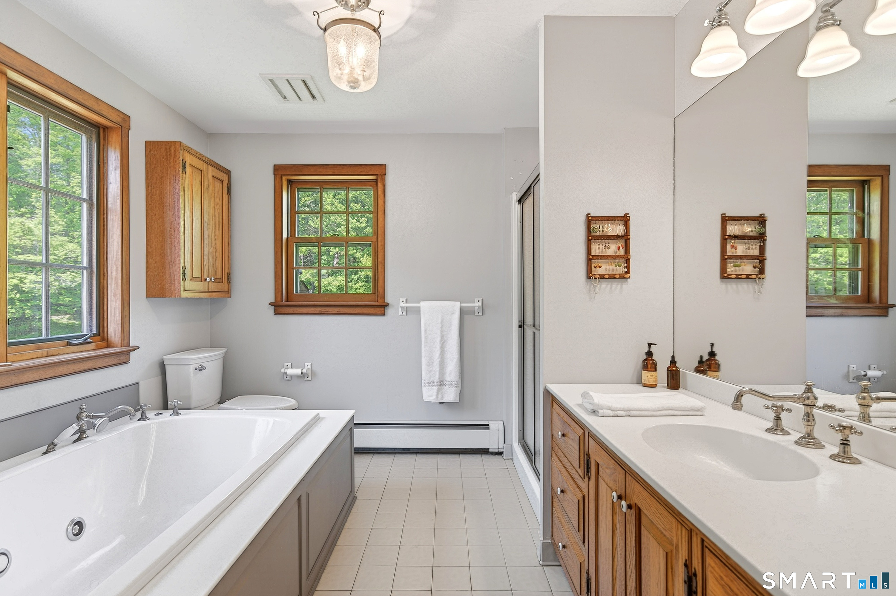 174 Huntingtown Road Newtown, CT 06470 - Photo 25 of 40 a bathroom with a tub sink and mirror