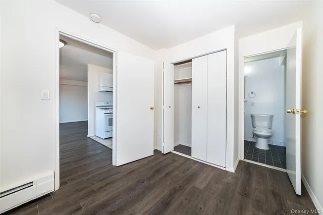 a view of bathroom with a toilet a sink and a mirror