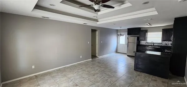 a view of a kitchen with a stove cabinets and a ceiling fan