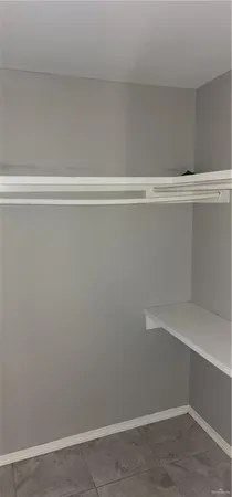 a view of a closet with wooden floor