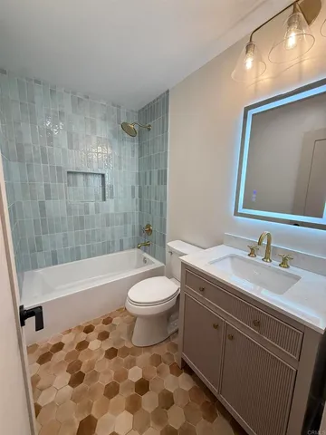 a bathroom with a sink a toilet and bathtub