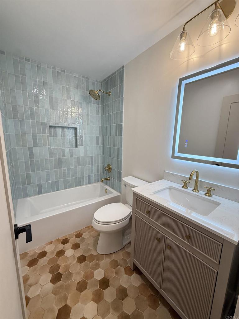 10296 Baroness Avenue San Diego, CA 92126 - Photo 11 of 27 a bathroom with a sink a toilet and bathtub