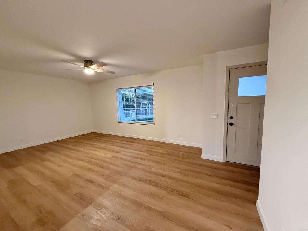 10296 Baroness Avenue San Diego, CA 92126 - Photo 13 of 27 an empty room with wooden floor fan and windows