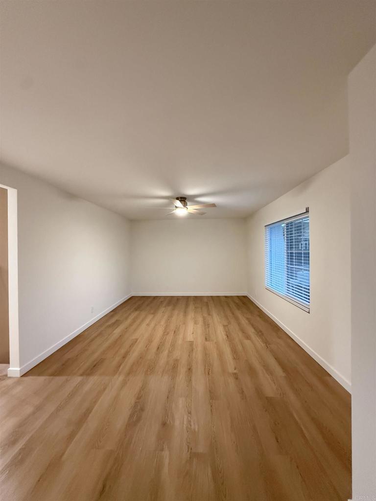10296 Baroness Avenue San Diego, CA 92126 - Photo 14 of 27 a view of empty room with wooden floor