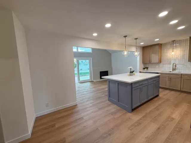 a large room with a window and wooden floors