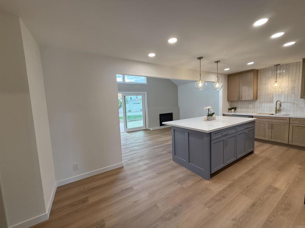 10296 Baroness Avenue San Diego, CA 92126 - Photo 16 of 27 a large room with a window and wooden floors