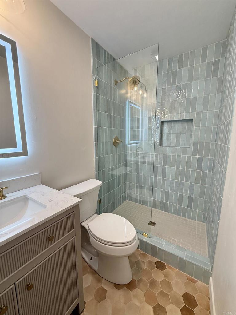 10296 Baroness Avenue San Diego, CA 92126 - Photo 22 of 27 a bathroom with a sink toilet and shower