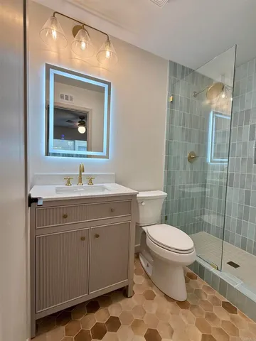 a bathroom with a sink toilet and shower